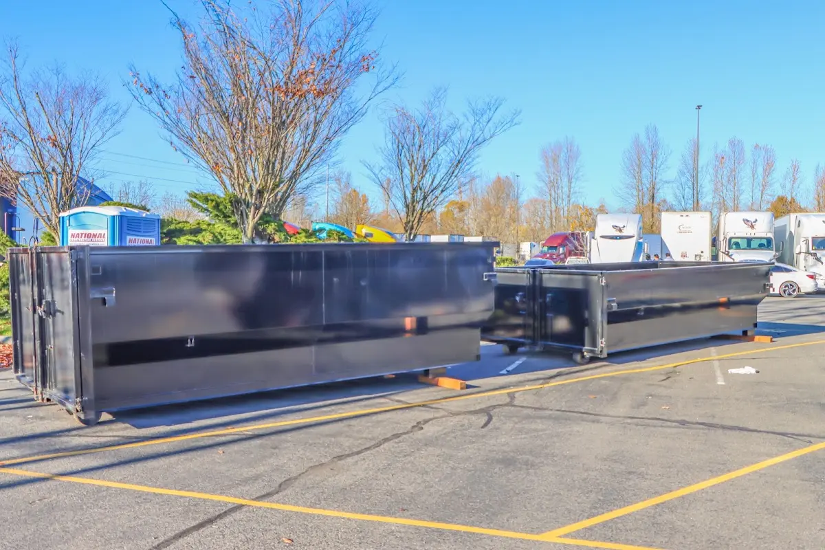 Professional dumpster rental service with roll-off container on residential driveway in North Mankato